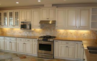 white kitchen with granite tops and backsplash